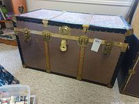 Front view of steamer trunk showing hardware and overall form