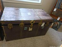 Front and top view of trunk showing hardware, canvas covering, latch configuration