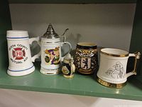 Five steins displayed on shelf