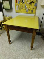 angled view of wood table with yellow laminate top