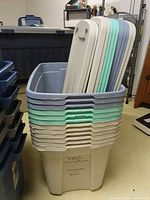 Stack of eleven plastic totes with stacked lids showing colour variety