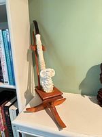 Full view of pipe on wooden stand