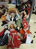 Group of dolls on shelf showing variety of national costumes