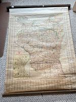 Full view of rolled-down Wisconsin wall map with wooden rods and inset city map