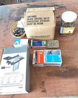 Workbench view: drawer joint jig box, nail carton, screw jar, staple & brad boxes, washer cup