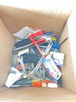 Box containing loose hand tools, screwdrivers, wrenches, hardware packages