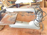 Full view of Beaver scroll saw showing cast metal body table and power cord