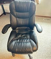 Front view of black faux leather office chair