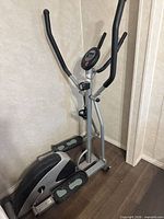 Full view of the CardioStyle ET150 elliptical trainer showing frame, pedals, handles, and console