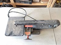 Top view of entire scroll saw showing table, arm, cord