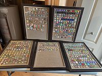 Overall view of five framed cork boards filled with pins