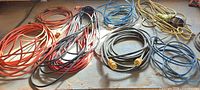 Overall view of coiled extension cords in assorted colors and lengths