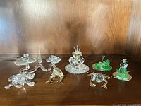 Group shot of all eight miniature frog figurines on shelf