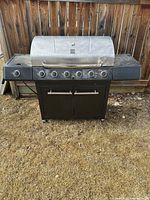 Full view of grill showing lid, burners, cabinet