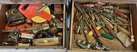 Two drawers filled with assorted tape measures, squares, utility knives, screwdrivers and small hand tools