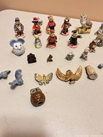 Group shot of assorted teddy bear, animal, insect and bird figurines displayed on tabletop