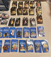Group of black-card character pins and blue Magical Milestones pins
