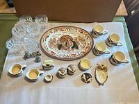 Group shot showing all items: platter, glasses, owl ceramics, silver-tone pieces