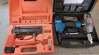 Both brad nailers in their open carrying cases with accessories