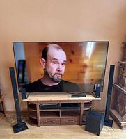 Full setup showing Samsung TV on stand with Sony towers, subwoofer and Blu-ray unit