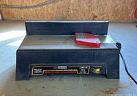 Front view showing Craftsman label, fence, red blade guard, power cord