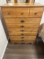Front view of tallboy chest showing all drawers and hardware