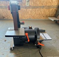 Front view of VEVOR belt and disc sander showing belt arm, disc, work table and adjustment levers