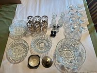 Entire lot laid out: bowls, glasses, cruets, shakers, metal trays