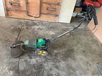 Full view of Weed Eater WTS80 walk-behind electric trimmer showing wheels, handle, guard and overall wear