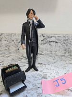 Full view of Ichabod Crane figure standing beside open satchel