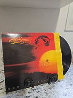 Front of Air Supply "Now and Forever" album jacket with record partially visible