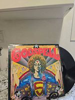 Front sleeve artwork and partial view of vinyl record