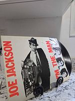 Front cover showing artist, title and vinyl partially removed