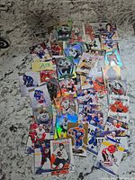 Pile of assorted NHL trading cards spread on countertop