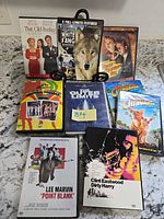 All eight DVD cases arranged on countertop showing front artwork and titles