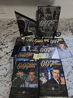 Overall view showing multiple James Bond Ultimate Edition DVD cases, slipcases, and collector packaging, visible titles Moonraker and You Only Live Twice