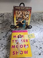 Front view of both DVD sets showing covers and identification tag