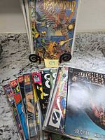 Front view showing Hawkworld on stand and stacks of bagged comics including Butcher Baker