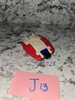 Top view of Solardyn spaceship showing red and white body and blue front detail