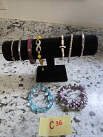 All eight bracelets on display rod and countertop
