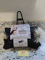 Front view of packaged Noize dog parka with faux fur hood trim