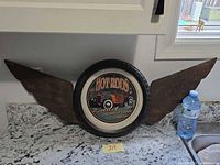 Full view of winged HOT RODS sign on countertop