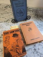 Front covers of all three books displayed upright and flat