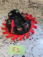 Top view of Roton showing black body, red blade ring, red guns, E1 tag
