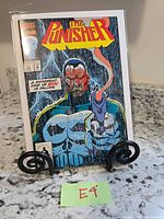 Front view of bagged The Punisher issue 23 comic on stand