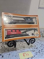 Front of sealed Tyco two-car box showing red Santa Fe caboose and blue car