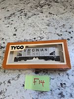 Front of boxed Tyco Virginian hopper car showing item through window