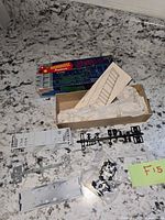 Box, instruction sheet and kit parts spread out on counter
