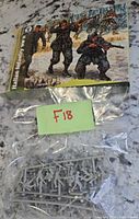 Front of box with illustration and bagged grey plastic sprues visible