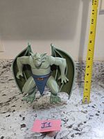 Front view of Broadway figure with measuring tape showing height ~9 in